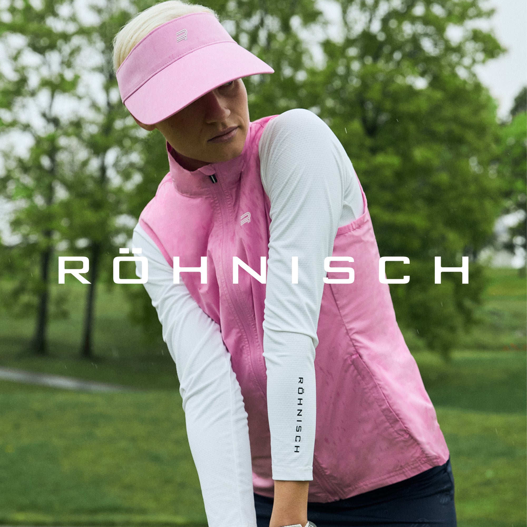 Woman golfing in the rain wearing Röhnisch gilet from the SS25 ladies golf clothing collection
